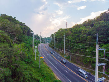 Road amidst trees against sky