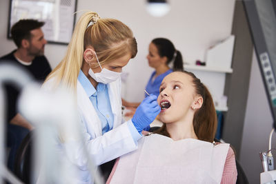 Dentist examining patient mouth in hospital