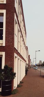 Street amidst buildings against clear sky