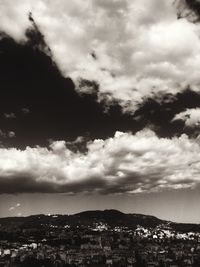 Cityscape against cloudy sky