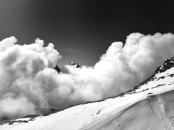 Low angle view of snowcapped mountain against sky