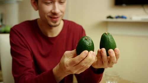 Close-up of man holding fruit