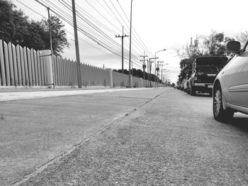 Cars on street in city against sky