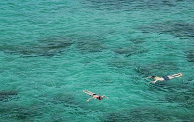 High angle view of people swimming in sea