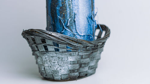 Close-up of wicker basket on white background