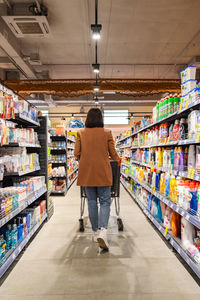 Rear view of man standing in supermarket