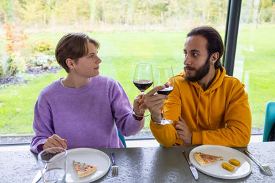 Young woman drinking beer at restaurant