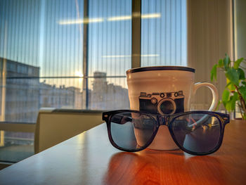 Close-up of glasses on table at home