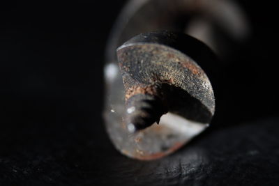 Close-up of rusty metal against black background