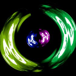 Close-up of illuminated lighting equipment against black background