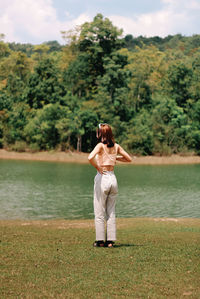 Rear view of woman standing on shore