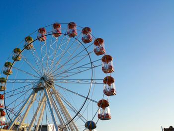 Low angle view of ferris wheel against clear sky