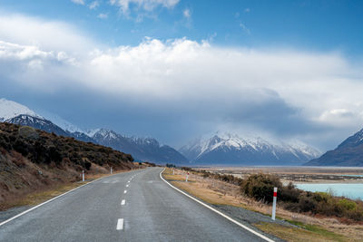 Mount cook road alongside lake pukaki with snow capped southern alps in winter evening light. 