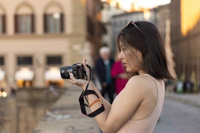 Portrait of photographer woman unfocused background at florence, italy. 50mm lens