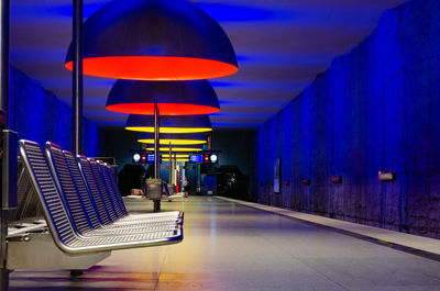 Empty illuminated subway station platform