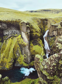 Scenic view of sea against sky iceland cliff river water fjord green grass holiday travel hiking