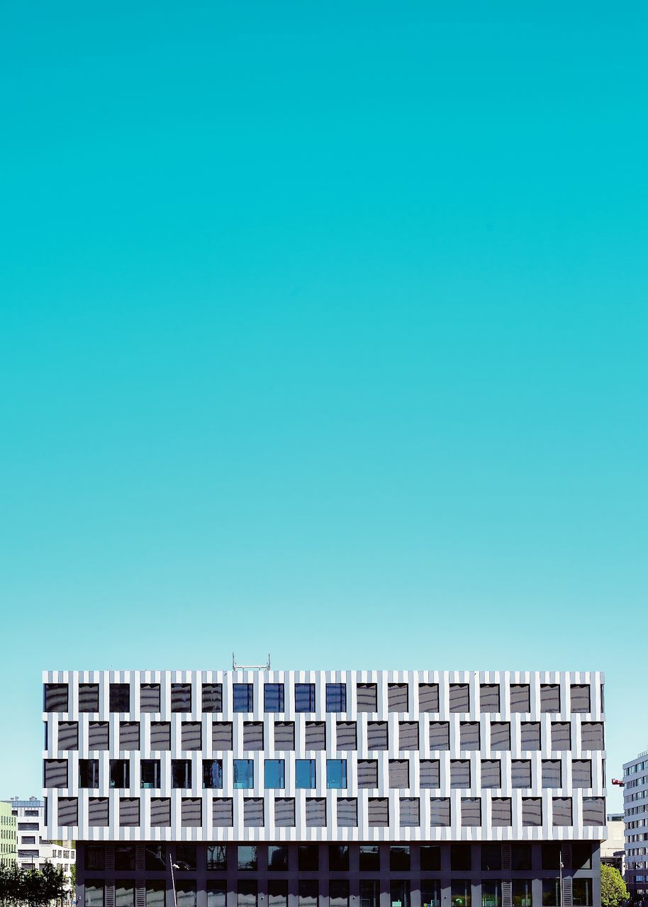 LOW ANGLE VIEW OF BUILDINGS AGAINST BLUE SKY