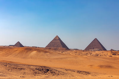 View of desert against clear blue sky