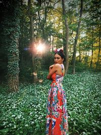 Woman standing by tree