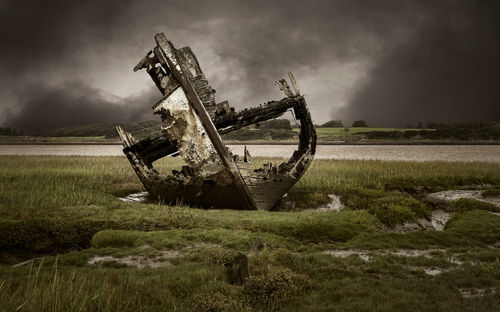 Abandoned structure on field against sky