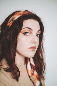 Close-up of young woman against white background