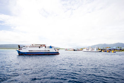 Ship sailing on sea against sky