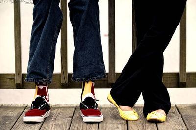 Low section of friends standing on floorboard