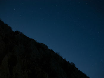 Scenic view of mountains against sky at night