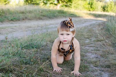 Portrait of cute baby girl in grass