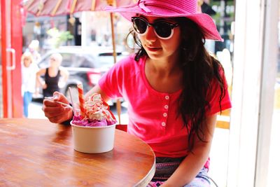 Teenage girl having ice-cream in cafe