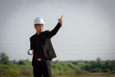 Full length of man standing on field against sky