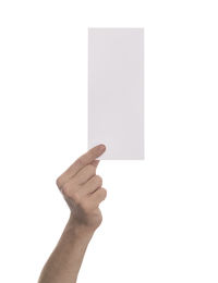 Close-up of hand holding paper against white background