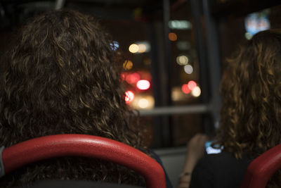 Rear view of women sitting in bus