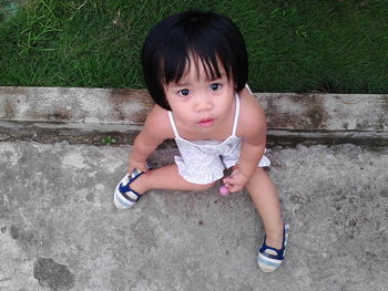 Portrait of a girl sitting outdoors