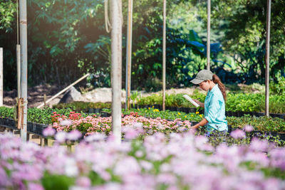 Woman working on flowering plants