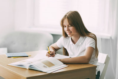 Young woman sitting on table