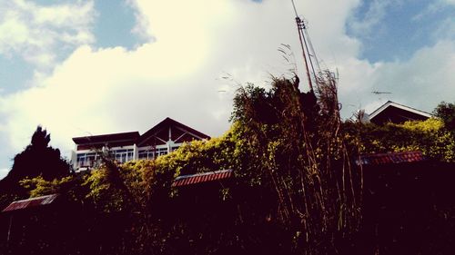 Houses against cloudy sky