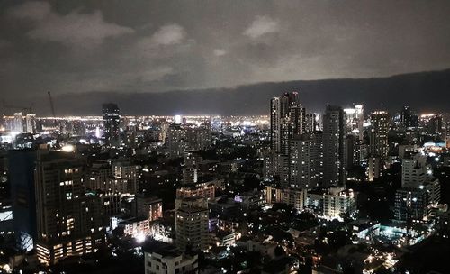 High angle view of illuminated city buildings at night