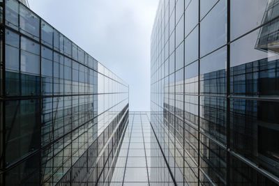 Directly below shot of office building against sky