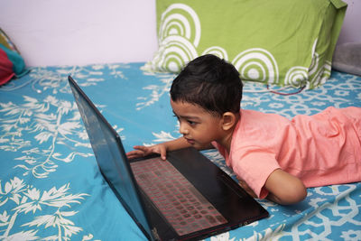 Young woman using laptop at home