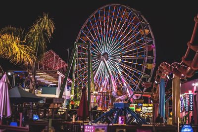 Low angle view of illuminated ferris wheel