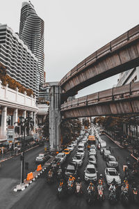 Traffic on city street and buildings against sky