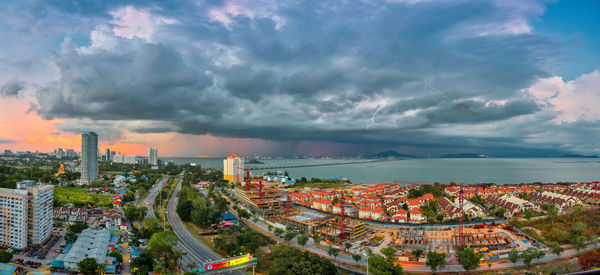 High angle view of road by buildings against sky