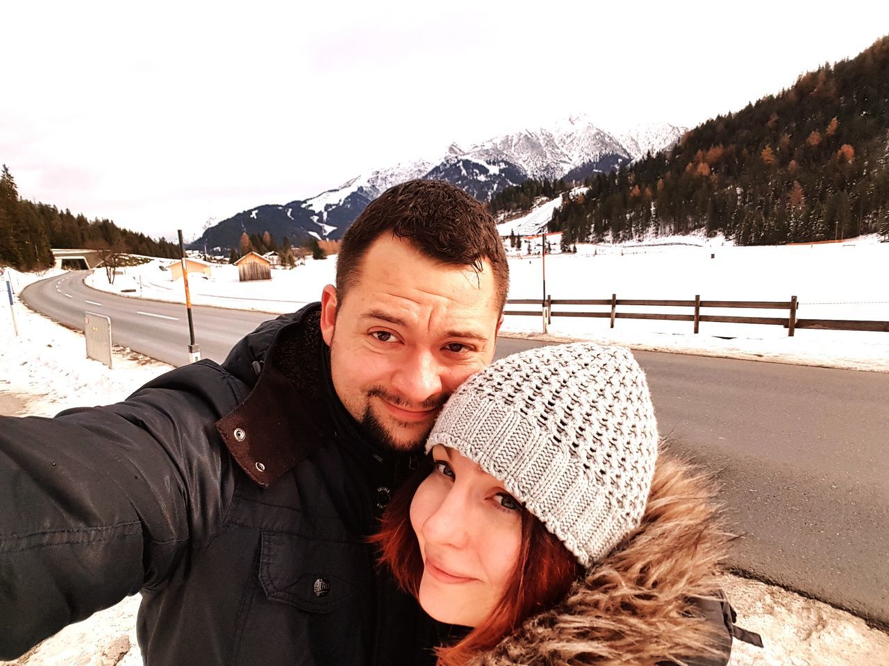 winter, snow, looking at camera, cold temperature, portrait, smiling, warm clothing, happiness, mountain, leisure activity, real people, nature, two people, young adult, lifestyles, young women, day, togetherness, young men, outdoors, vacations, selfie, ski holiday, mountain range, beauty in nature, sky