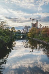 Bridge over river against cloudy sky