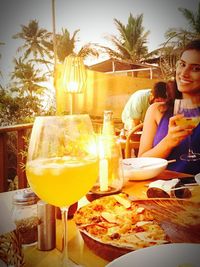 Friends drinking glass on table