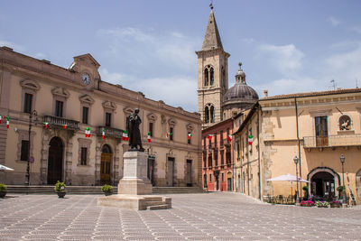 Buildings in city against sky