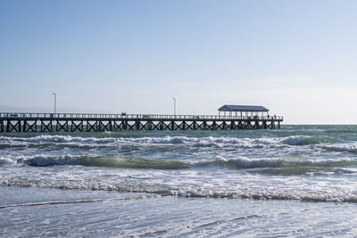 Pier over sea against clear sky