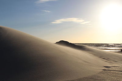 Scenic view of beach against sky during sunset