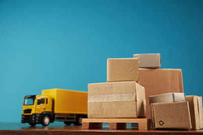 Low angle view of boxes against clear blue sky